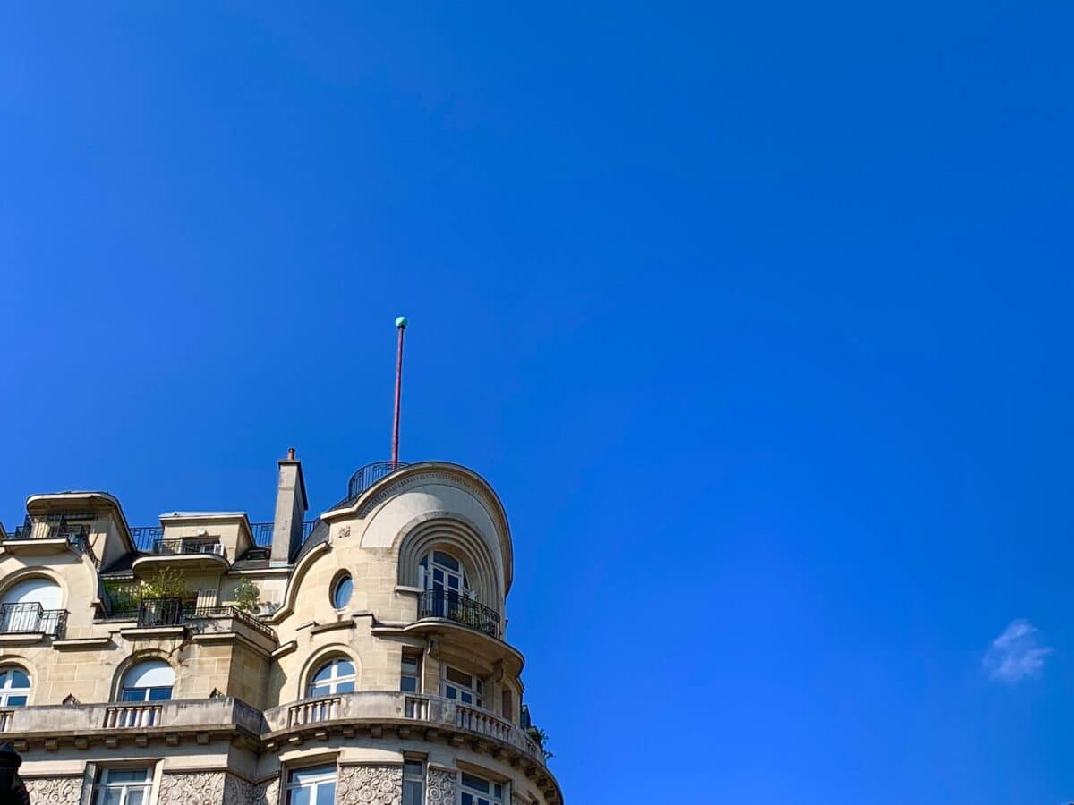 a tall building with a flag on top of it